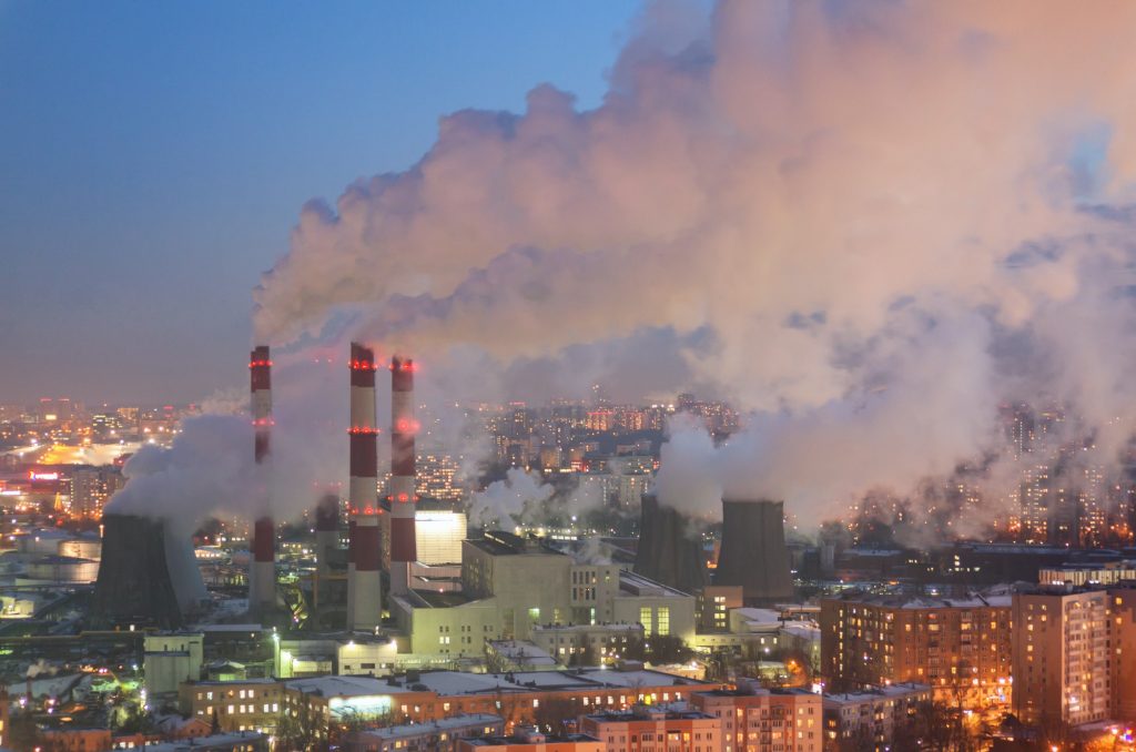 Steam and smoke from the chimneys and cooling towers city Central Heating and Power Plant